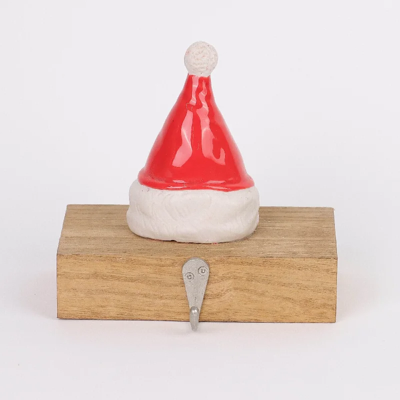 Ceramic Santa's hat with
wooden base stocking holder